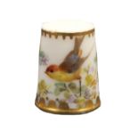 A Worcester porcelain thimble painted with a bird and flowering branches below a line and dot gilt