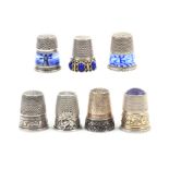 Seven continental, mainly German white metal thimbles, comprising two with Dutch style enamel