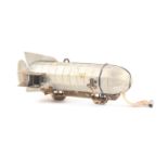 A rare Zepplin or airship novelty tape measure in mixed metals, wound from the side propeller,