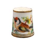 An English porcelain thimble circa 1830, painted with a bird amid flowering branches Internal