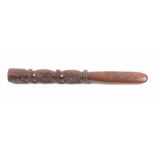 A carved fruitwood 19th Century knitting stick the short paddle blade carved to each side with two