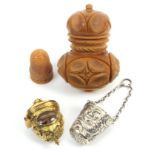 Three thimble cases, comprising a large vegetable ivory example complete with thimble with pierced