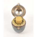 An unmarked silver egg form sewing companion, circa 1880, hinged cover with suspension ring, the