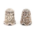 Two Indian Kutch silver thimbles, the first well detailed with flowers and leaves over conforming