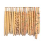 Nineteen 19th Century wooden Devon bobbins comprising eight with incised and colour decoration