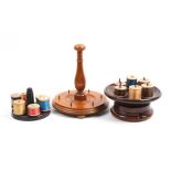 A mixed lot – sewing – comprising two wooden circular reel stands, another in plastic with central