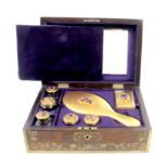 A rosewood and cut brass inlaid dressing case of rectangular form, the lid and front with foliate
