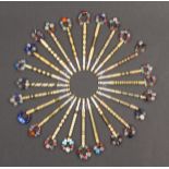 Twenty four 19th Century bone lace bobbins all bound with brass wire mostly with coloured spots