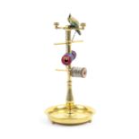An attractive 19th Century brass reel stand, the circular base on three ball feet the baluster