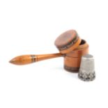 An unusual combination thimble/needlecase in the form of a boxwood gavel with penwork borders,