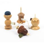 Four vegetable ivory tape measures comprising a standing example with waxer and pin cushion,