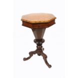A Victorian trumpet form walnut tripod sewing table with chess board top, compartmentalised interior