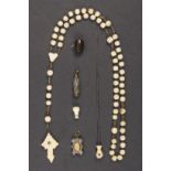 Six objects incorporating Stanhopes comprising a bone cross and beads (French views – a little