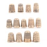 Thirteen English silver thimbles including some Reg. and Spa (13)