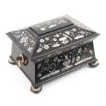A fine sarcophogal form ebony and cut pearl inlaid sewing box, circa 1860, the angled front and