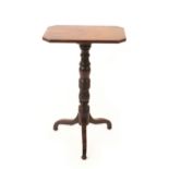 A William IV mahogany tripod table, the canted rectangular top on turned and carved pedestal and