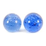 Two heavy ball form aerated blue glass ‘dump’ door stops, 14cm high (2)