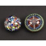 Two glass paperweights comprising a 19th Century St Louis example, 5cm and another with star base,