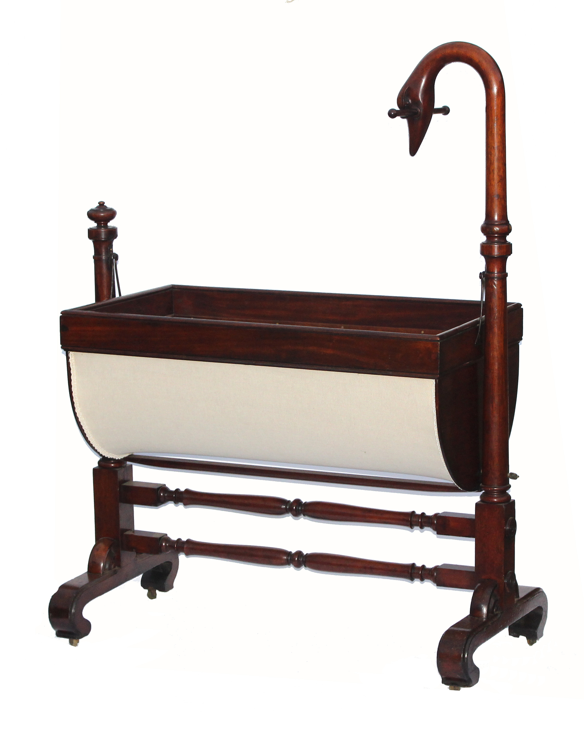 A William IV mahogany cradle, the cradle with anthemion pierced ends below a carved birds head, on