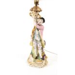 A Paris porcelain figural lampbase, late 19th century, modelled with a boy alongside a cornucopia of