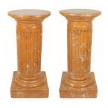 A pair of 19th Century scagliola pedestals of fluted column form with circular tops on socle bases