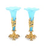 A pair of 19th Century blue glass vases with wavy rims in gilt metal floral mounts, 27cm (2)