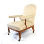 A mid Victorian burr maple frame library chair, arched back over padded arms on turned supports, the
