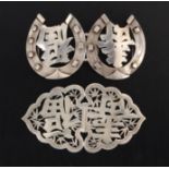 Two 19th Century Chinese silver lady’s buckles comprising a two-part script pierced example, 11.5cm,