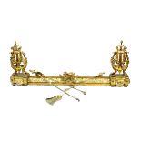 A pair of early 20th century lyre form gilt brass chenets, on paw feet and rectangular bases,