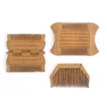 Three 19th Century boxwood combs comprising a hinged example opening to form four combs with variant