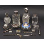A mixed lot silver and white metal comprising five silver mounted dressing table bottles, a