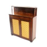 A Regency rosewood chiffonier, enclosed by a pair of brass grille doors with pleated linings,
