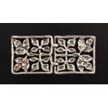 A lady’s silver buckle, each half pierced and cast with four panels of leaves within a rectangular
