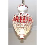 A Bohemian overlay glass light fitting in white and cranberry decorated with flowers and hung with