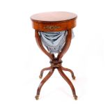A Louis Philippe burr walnut sewing table, the hinged circular top over a plain frieze, on four