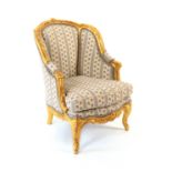 A Louis XVI style giltwood small fauteuil, the moulded and floral carved frame on carved cabriole