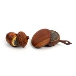 Two 19th Century nutmeg graters comprising a coquilla nut acorn form example with turned decoration,