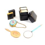 Five pieces comprising an enamel handled magnifying glass, 10cm, a 9ct gold miniature hand mirror,