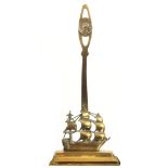 A brass doorstop cast in the form of H.M.S. Victory, the handle with a medallion of Nelson, 45cm