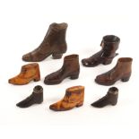 Eight various shoe ornaments comprising a fruitwood pair with sliding lids, 7.6cm, a pair of straw