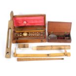 Scientific related items comprising a mahogany cased Sikes Hydrometer, lacking thermometer, 25.