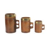 A set of three 19th Century graduated grain measures each carved from the solid with a twin ring