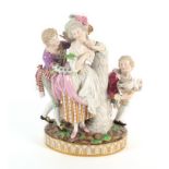 A large 19th Century Meissen figure group of a lady beside a pillar a gallant to one side, a