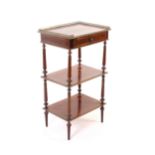 An early 20th century French mahogany étagère, inlaid and edged in brass, the gallery top over a