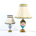 Two table lamps comprising a Minton style porcelain example the turquoise ground with four panels of