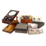Two optical viewers and a boxed set of stereoscopic cards, comprising an amboyna and ebonised