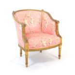 A 19th Century Louis XVI style gilded frame tub chair covered in cherub print