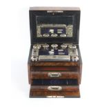 A mid Victorian figured walnut fitted travelling box of rectangular form brass lid plaque and