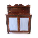 A Regency rosewood chiffonier, enclosed by a pair of doors with pleated silk linings, flanked by
