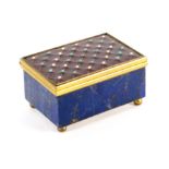 A blue lapis rectangular gilt mounted box, the lid with an inset red enamel plaque with a trellis